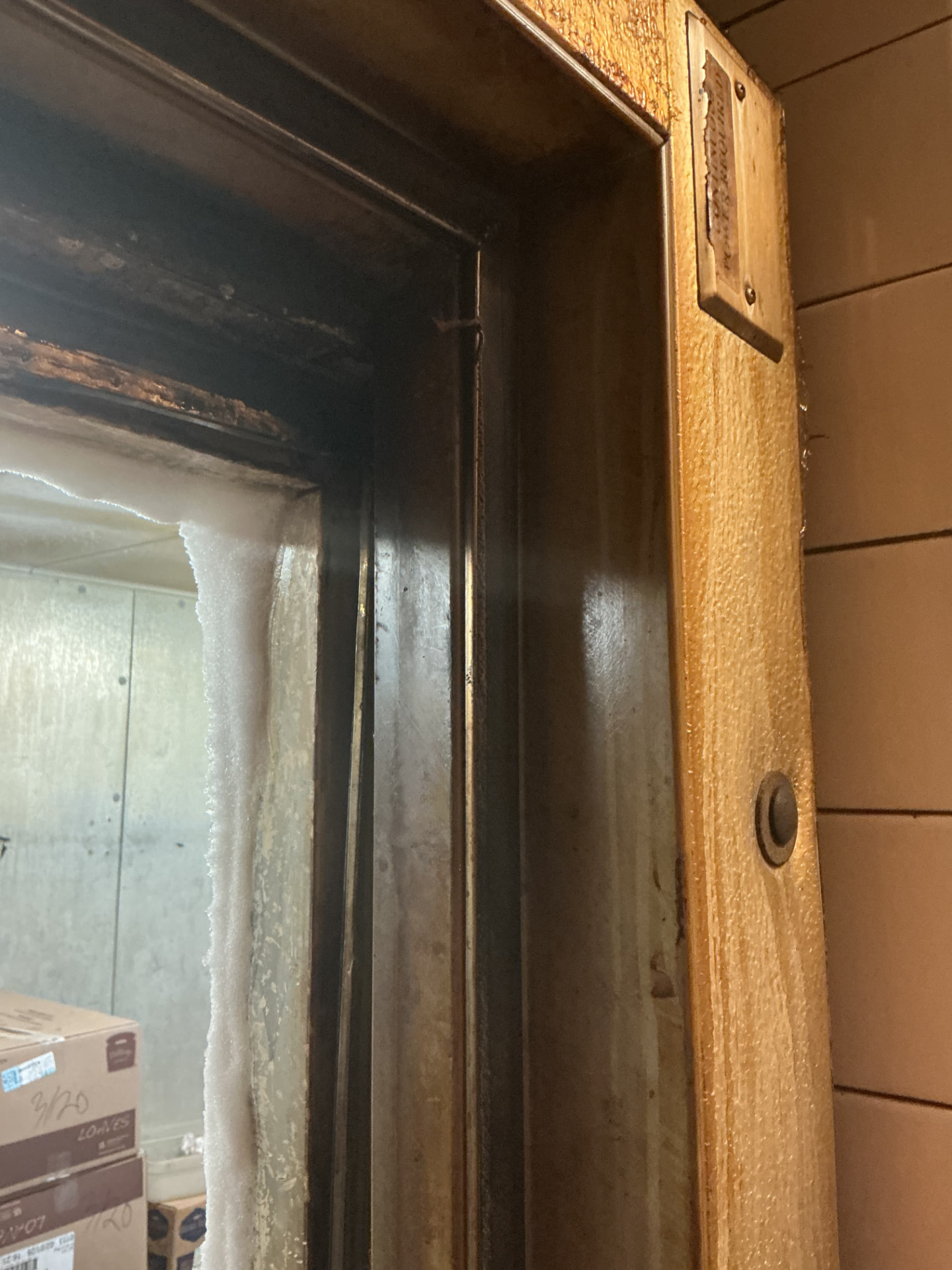 Frost and ice built up along a walk-in freezer door frame